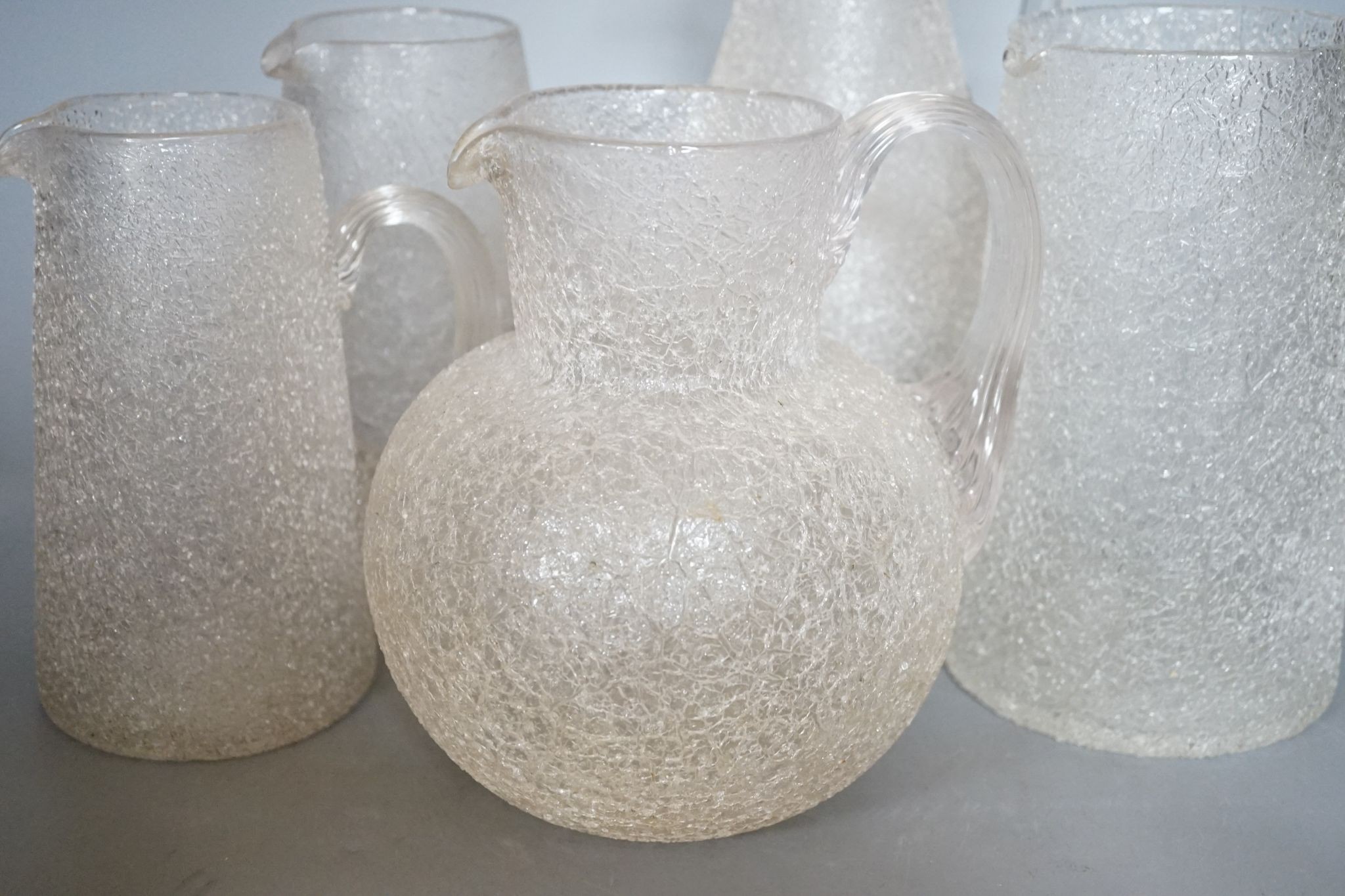 Five various Victorian iced glass jugs, 29cm